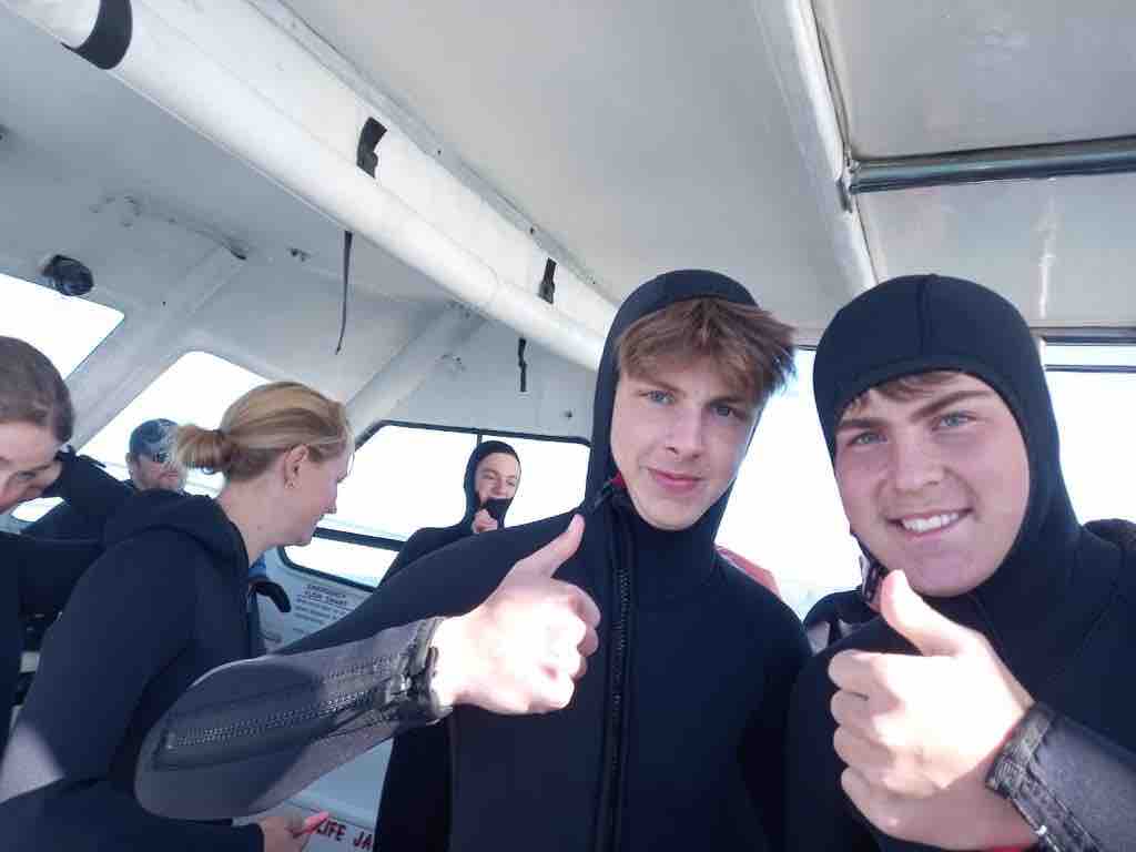 happy clients throw thumbs up on sharklady adventures trip